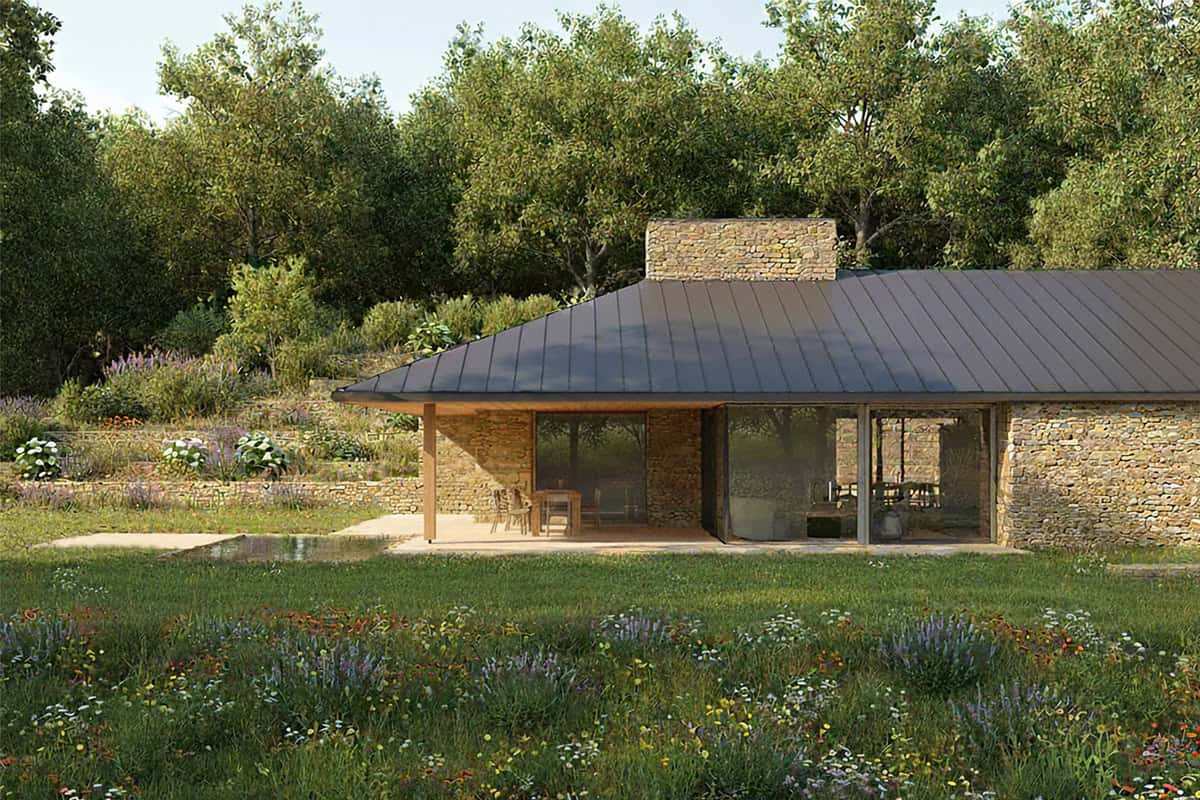 Abnash View covered terrace with stone walls, metal roof, and wildflower meadow, Cotswolds Passivhaus home
