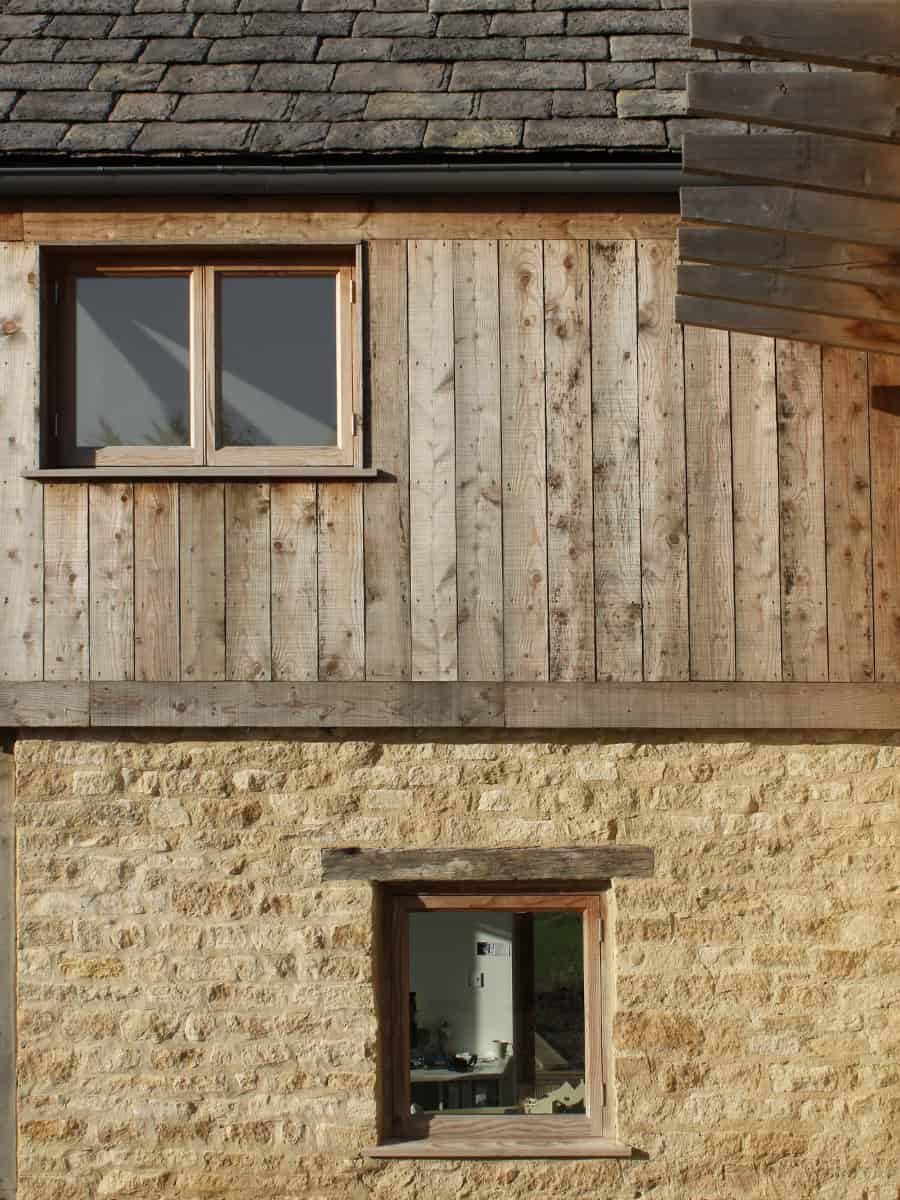 Cockadilly facade detail showing Cotswold stone, larch timber cladding and slate roof